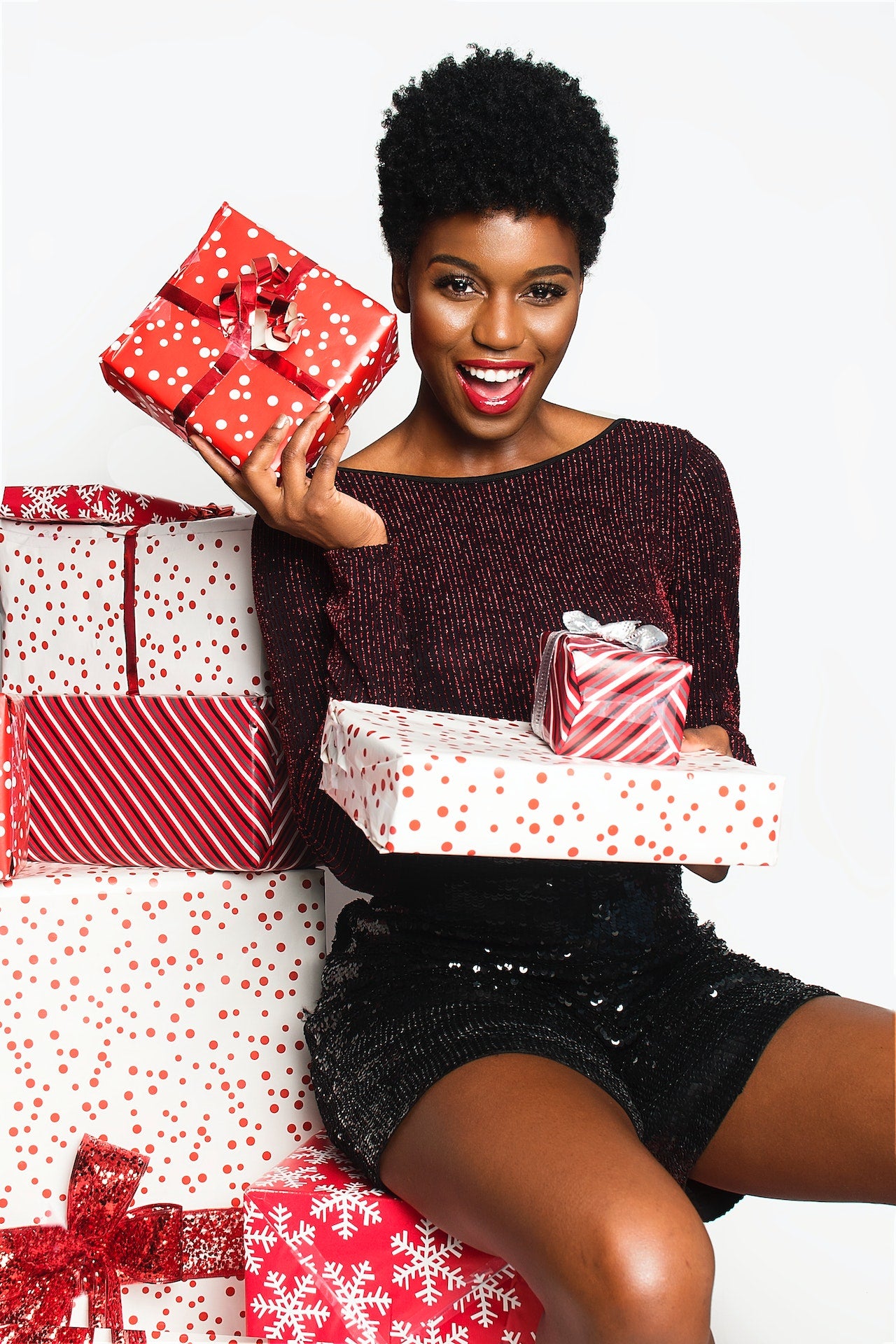 Lady sitting with a stack of present shopping with confident from Adrenaline Laser Craft